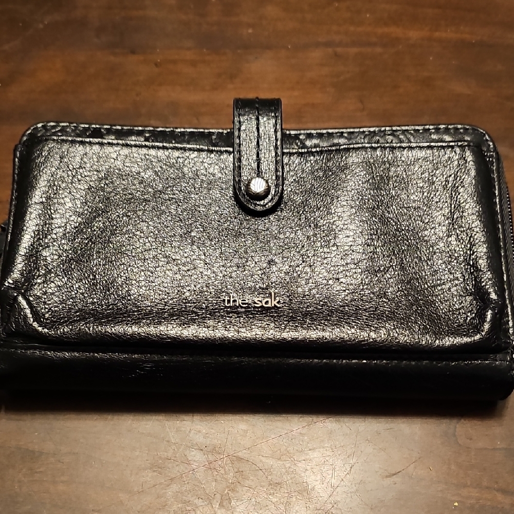 The Sak Black Leather Wallet Excellent Condition. Cross Body Strap And Wristlet.